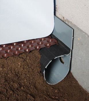 Closeup of a crawl space drainage system installed in South Park
