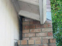 A chimney leaning away from the home on a White foundation