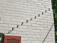 Stair-step cracks showing in a home foundation in Greensburg