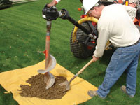 Auguring a hole in the earth for a foundation wall repair system in Allison Park