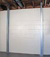 A steel i-beam system installed on a Cecil foundation wall