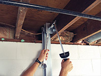 Straightening a foundation wall with the PowerBrace™ i-beam system in a New Castle home.