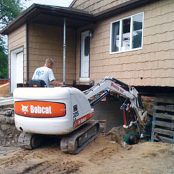 Excavating to expose the foundation walls and footings for a replacement job in Mc Kees Rocks