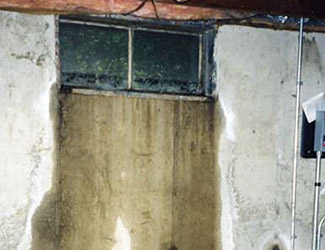Water pouring out from a basement window in Morgantown